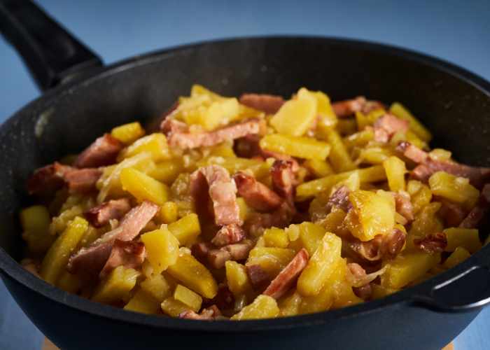 fried potatoes and ham in a cast iron skillet