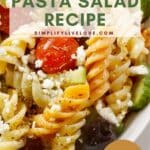 asiago pasta salad with olives, tomatoes, and cucumbers in white serving dish