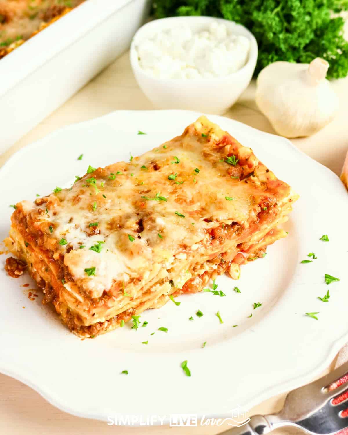Slice of cottage cheese lasagna on a white plate