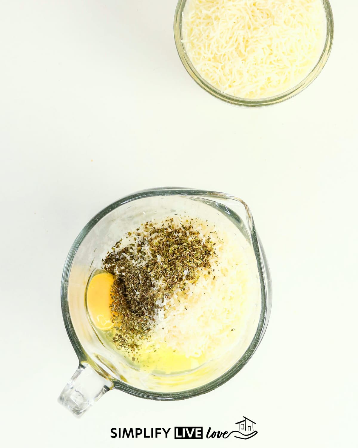 Mixing cottage cheese, mozzarella, eggs, and parsley for lasagna filling
