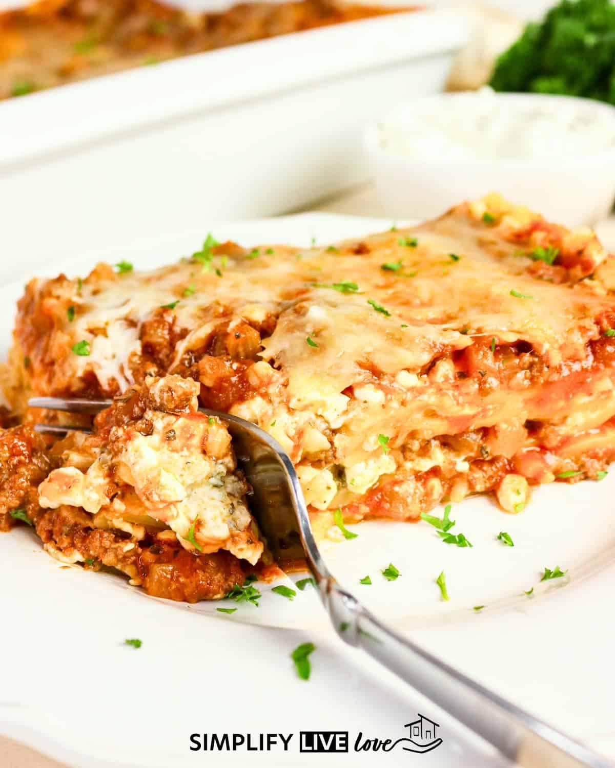 piece of lasagna on a plate with a fork