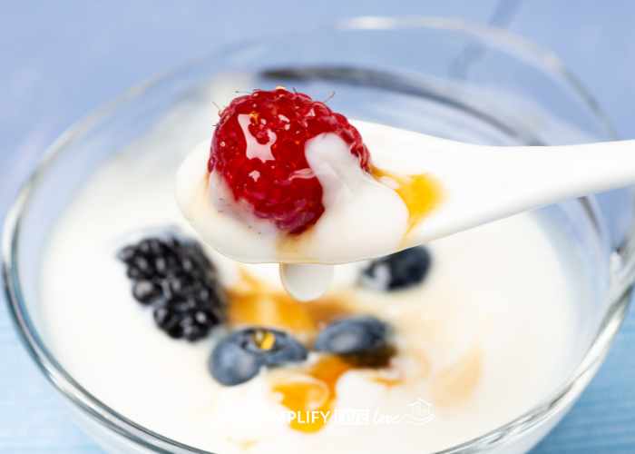 glass bowl with yogurt and berries