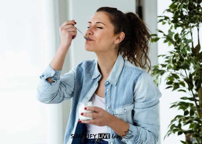 woman with ponytail eating plain full fat yogurt