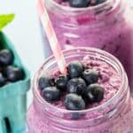 frozen green smoothie with blueberries in a glass jar