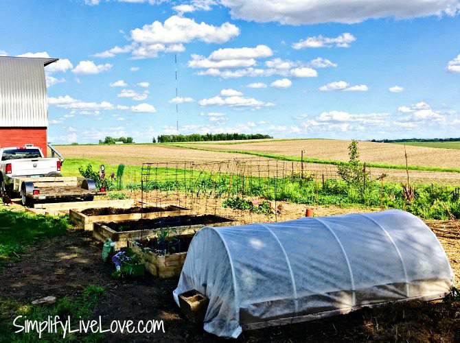 attach the fabric to one side of the raised garden bed