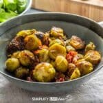 roasted brussels sprouts in dish with parmesan cheese and bacon