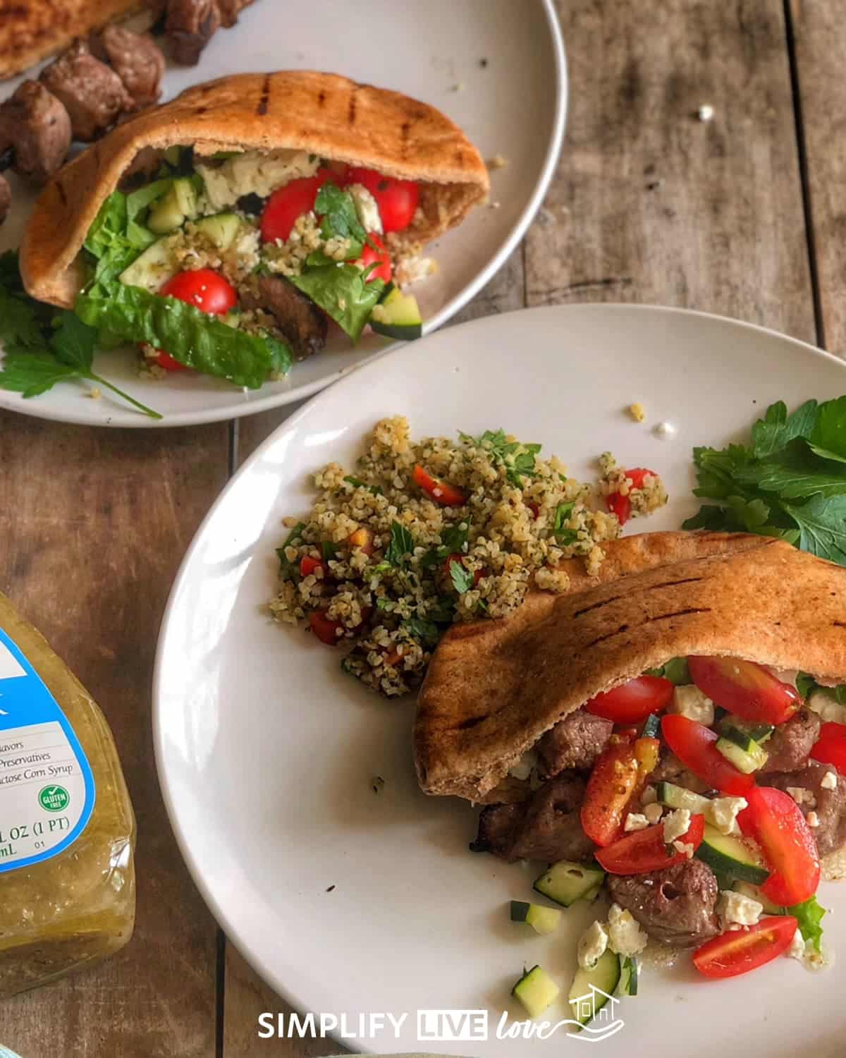 two plates of beef pita sandwiches
