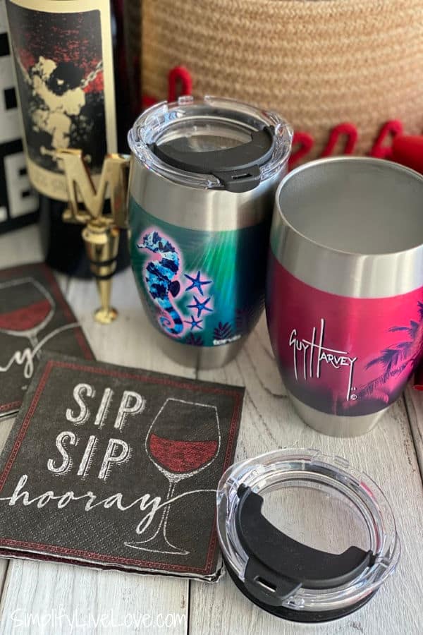 cocktail napkins and stainless steel wine tumblers on wooden table