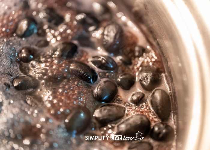 black beans in water boiling in pressure cooker