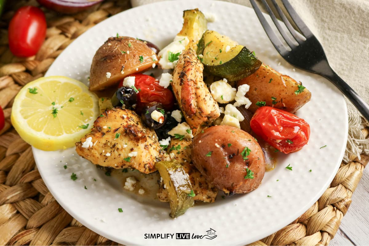 plated chicken, zucchini, tomato, olives